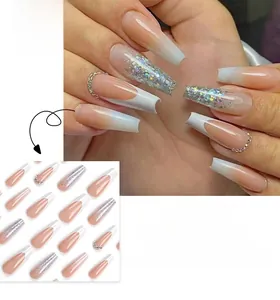 Detail of French tip press-on nails with silver glitter and coffin shape design