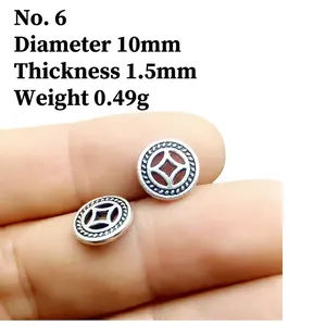 Macro detail of 10mm silver coin spacer with traditional pattern for DIY jewelry making