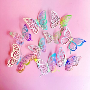 Set of 8 iridescent hollow butterfly cake toppers arranged in a ring on pink background