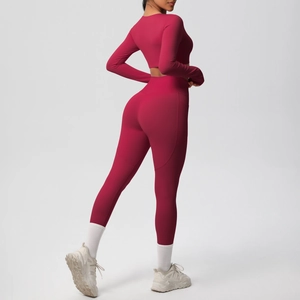 Detailed side view of high-waist yoga leggings and long sleeve crop top in dark red