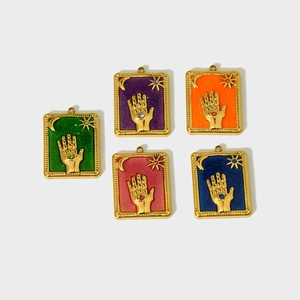 Macro view of five tarot charms with Fatima hand, moon, and stars in colorful drip oil