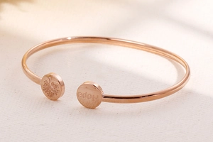 Detailed view of rose gold Tree of Life and Hope engraving on open titanium steel cuff