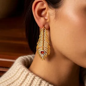 Vintage gold feather tassel earrings with crystal pavé and maroon drop gemstones