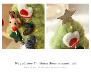 Macro detail of handmade wool felt Christmas tree with LED lights and deer decor