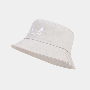Detailed close-up of a cream cotton bucket hat featuring a white embroidered ghost face