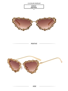 Detail of luxury gold cat eye sunglasses with brown rhinestones and gradient lenses