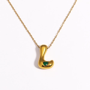 Detail of 18k gold plated bubble necklace with number 7 pendant and green heart stone