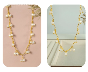 Detail of French style freshwater pearl necklace with wavy gold chain and dangling beads