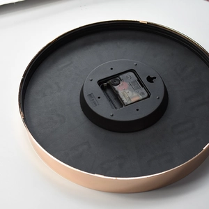 Modern 12-inch silent wall clock with rose gold metal frame and quartz movement back