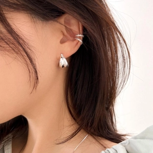 Detail of S925 sterling silver double arc stud earrings and ear cuff set on model