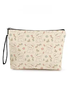 Detail of bunny and floral pattern on canvas makeup bag with black zipper and wristlet