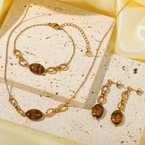 Vintage gold-plated stainless steel jewelry set featuring oval brown tiger eye stones