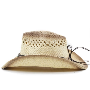 Detail of straw cowboy hat featuring vintage distressing and turquoise bead accent
