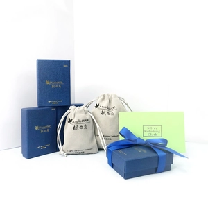 Premium jewelry packaging set with navy blue boxes, velvet pouches and a polishing cloth