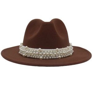 Close-up of pearl bead trim on a dark brown wide brim wool felt jazz fedora hat