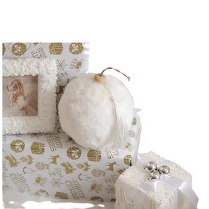 White faux fur Christmas ornament with wooden beads and tassel on a gift box