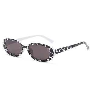 Retro oval sunglasses with black and white spotted texture frames and dark grey lenses