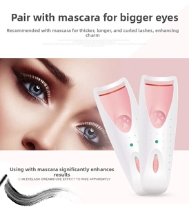 Detail view of electric eyelash curler with pink heat pad and cat paw design