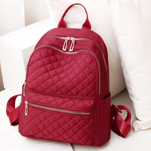 Red quilted nylon backpack with adjustable straps for women, stylish water-resistant travel bag