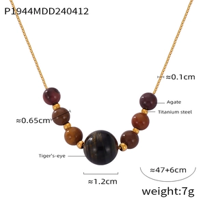 Close-up of golden titanium steel necklace with tiger's eye and agate beads detail