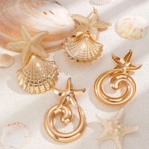 Exaggerated golden starfish and seashell earrings for bohemian beach vacations