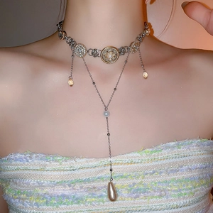 Luxurious layered choker with pearls, crystals, and a vintage medallion pendant