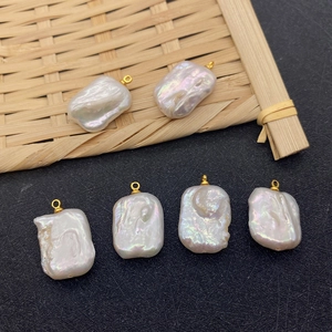 Natural baroque pearl pendant with irregular shape and golden metal ring connector