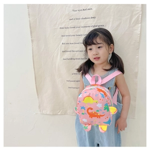 Pink waterproof nylon toddler backpack with cute cartoon dinosaurs on girl's back
