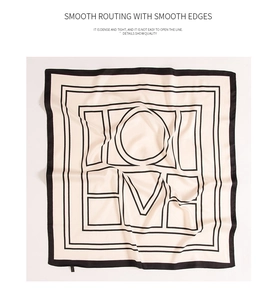 Detailed view of the beige silk scarf with black geometric patterns and smooth routing