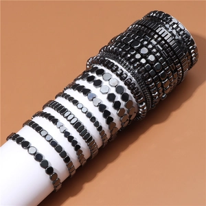 Detail of assorted hematite bead bracelets featuring heart, round, and hex shapes on a stand