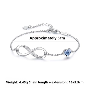 Detail of silver infinity bracelet with blue heart crystal and Zirconia accents