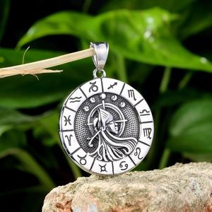 Macro shot of vintage stainless steel zodiac pendant with detailed celestial engraving