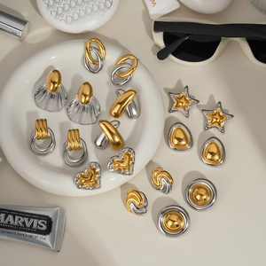 Detailed collection of two-tone gold and silver earrings in oval, star, and heart shapes