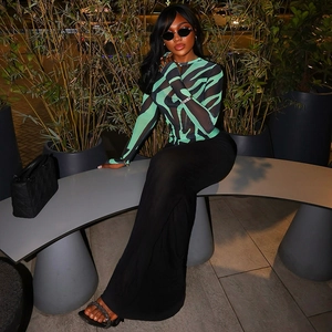 Close-up of zebra pattern mesh top and slim skirt shown in a stylish outdoor night scene
