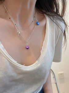 Detail of s925 silver double-layered necklace with colorful M-shaped bean pendants