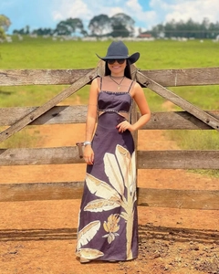 Detail of tropical plant print and waist cutout on long Hawaiian style summer dress