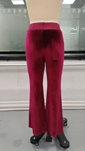 Rear view of burgundy velvet flare pants featuring a high-waisted design and soft texture