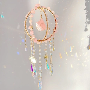 Detail of rose quartz suncatcher showing crystal prisms and rainbow light refraction