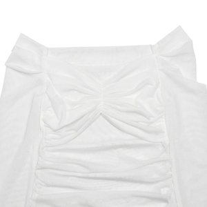 Detail of white off-shoulder top featuring ruched mesh fabric and intricate hollow out design