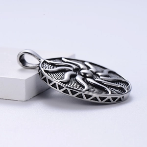 Vintage silver sun totem pendant in stainless steel shown from a 45-degree angle