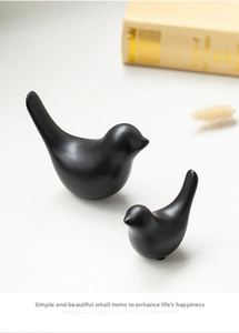 Macro shot of minimalist black matte ceramic bird figurines in a pair for home decor