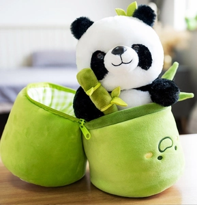 Cute panda plush toy inside a green bamboo-shaped storage bag for festive gift giving