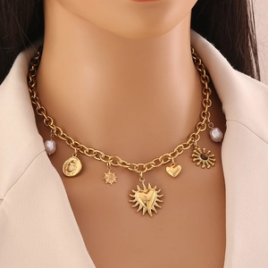 Gold-plated stainless steel necklace with sun, moon, and pearl charms worn by a model