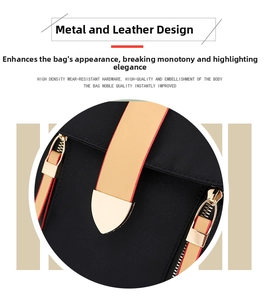 Detail of premium golden hardware and leather trim on a black Oxford fabric backpack
