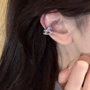 Silver horse-shaped ear cuff with sparkling zircon crystals worn on the ear bone