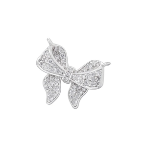 Detailed view of silver bow pendant with shimmering cubic zirconia and dual loops