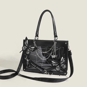 Macro view of gothic tote bag with spider web window and metallic chain details