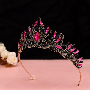 Detailed view of vintage bronze tiara with ruby red gems and black crystal embellishments