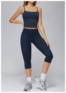 Detail of high-stretch navy blue yoga set featuring cross-back sports bra and leggings
