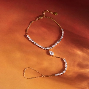 Gold stainless steel finger bracelet with rectangular and pear-cut zircon stones